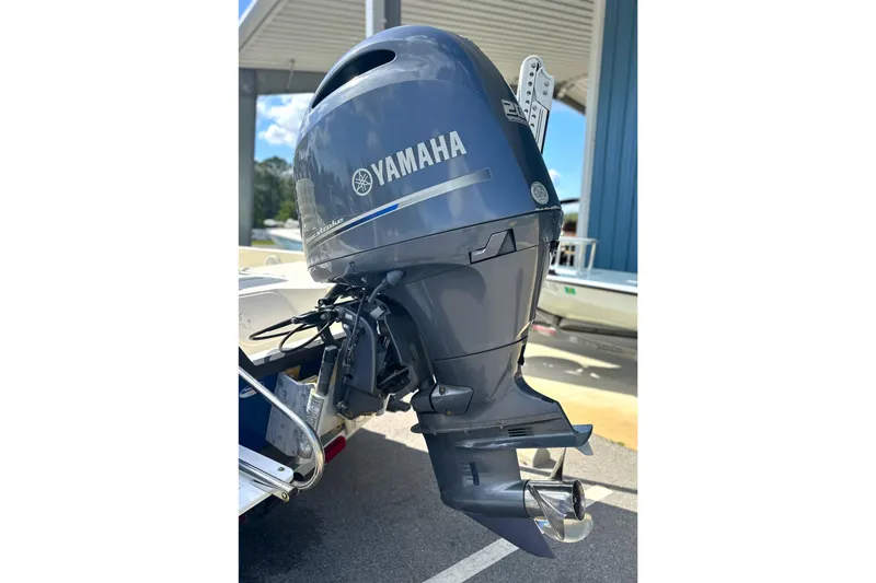 Slide: The Image of Yamaha outboard motor on a 2015 Skeeter SX220 T boat, parked outdoors. - 13