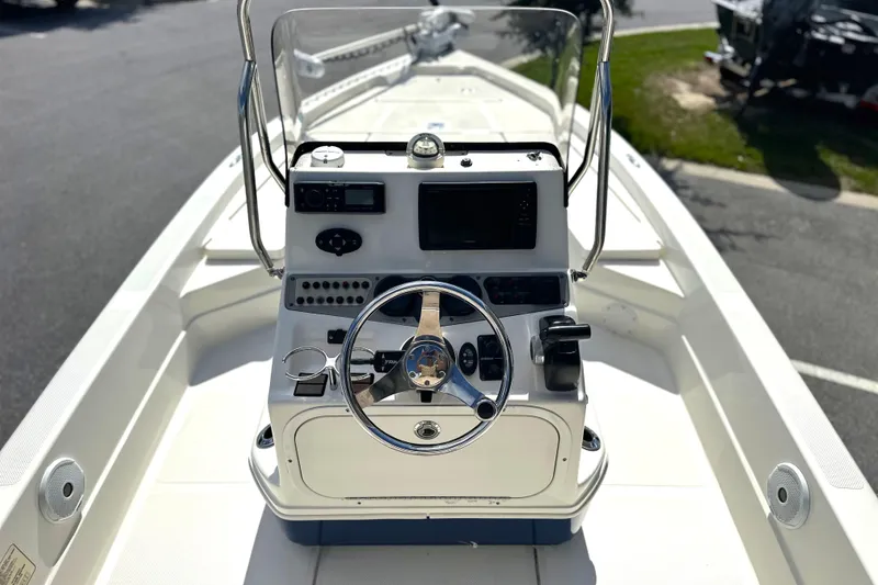 Slide: The Image of 2015 Skeeter SX220 T boat console with steering wheel and navigation controls. - 15