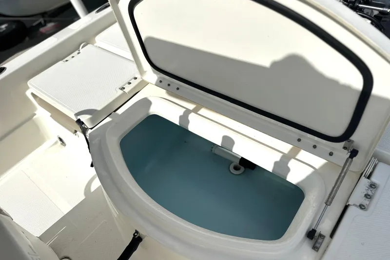 Slide: The Image of Open storage compartment on a 2015 Skeeter SX220 T boat, showcasing interior space. - 17
