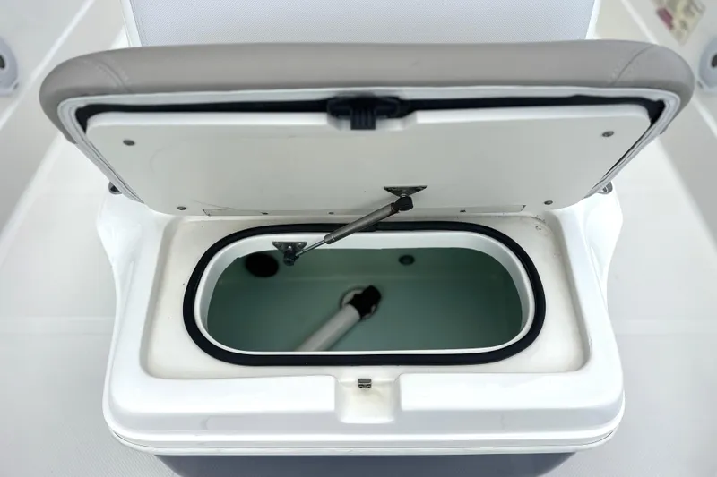 Slide: The Image of Open livewell compartment on a 2015 Skeeter SX220 T boat, showcasing interior details. - 24