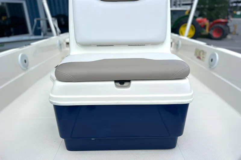 Slide: The Image of 2015 Skeeter SX220 T boat seat with blue storage compartment. - 25