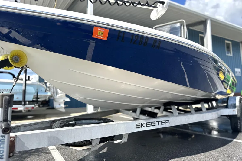 Slide: The Image of 2015 Skeeter SX220 T boat on trailer, Florida registration visible. - 3