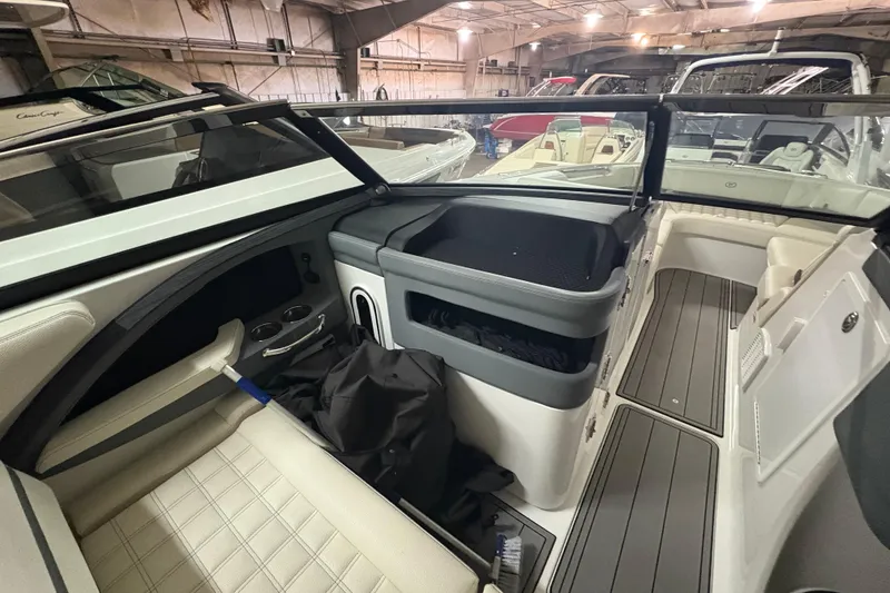 Slide: The Image of Interior of a 2021 Cobalt R30 boat, showcasing seating and storage in a showroom. - 14
