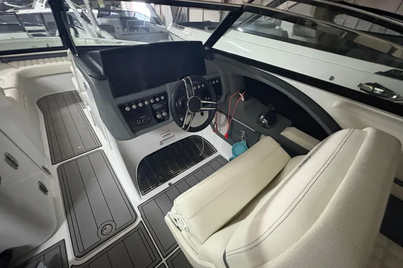 Slide: The Image of Interior view of 2021 Cobalt R30 boat cockpit with steering wheel and controls. - 16