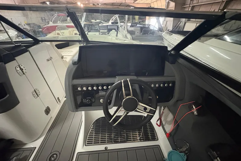 Slide: The Image of Interior view of a 2021 Cobalt R30 boat cockpit with steering wheel and control panel. - 17