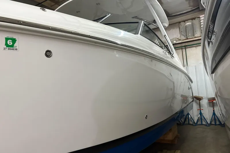 Slide: The Image of 2021 Cobalt R30 boat in storage, showcasing sleek white hull and modern design. - 2