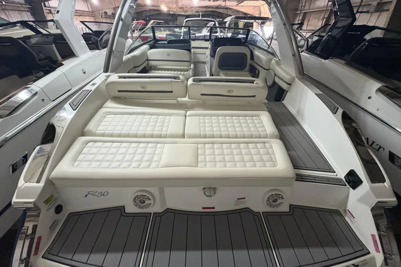 Slide: The Image of 2021 Cobalt R30 boat interior with luxurious white seating and sleek design. - 20
