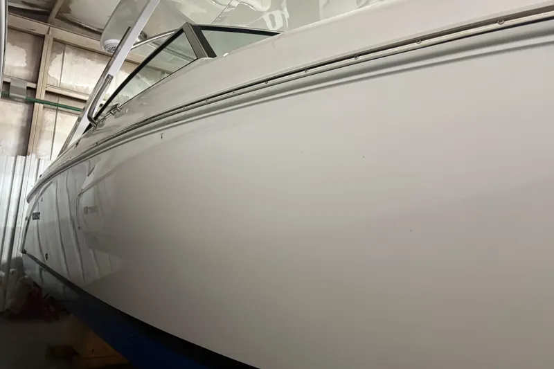 Slide: The Image of 2021 Cobalt R30 boat in storage, showcasing sleek white hull design. - 3