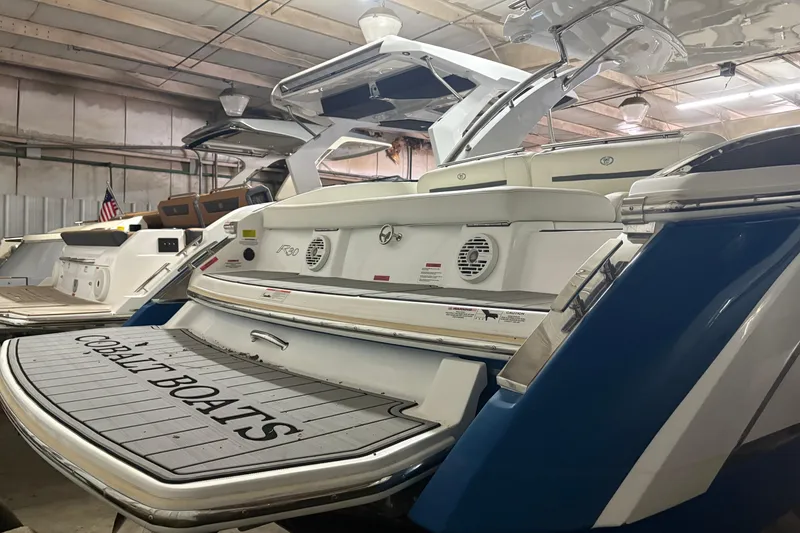 Slide: The Image of 2021 Cobalt R30 boat in showroom, featuring sleek design and spacious deck. - 5