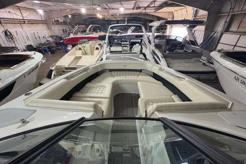 Slide: The Image of 2021 Cobalt R30 boat interior with luxurious seating in a spacious showroom. - 6