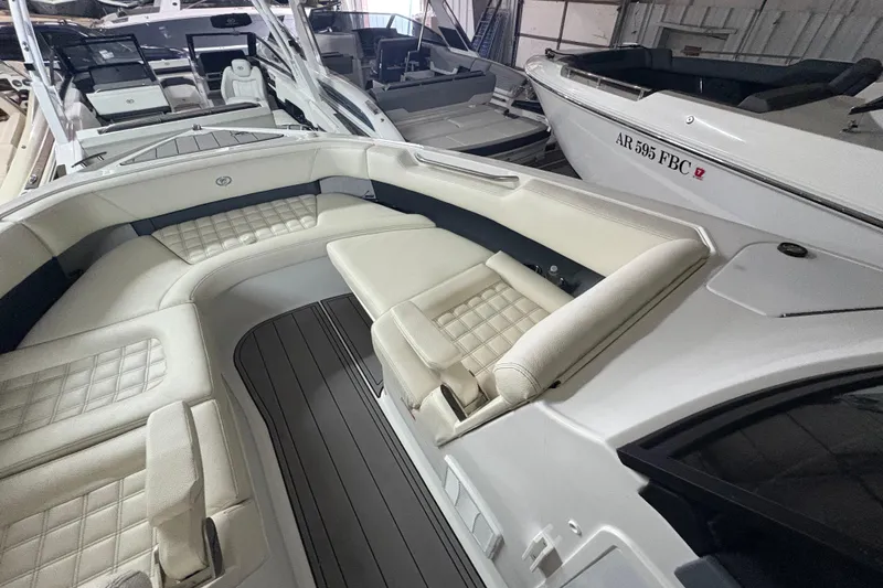 Slide: The Image of 2021 Cobalt R30 boat interior with luxurious seating and sleek design in a showroom. - 7