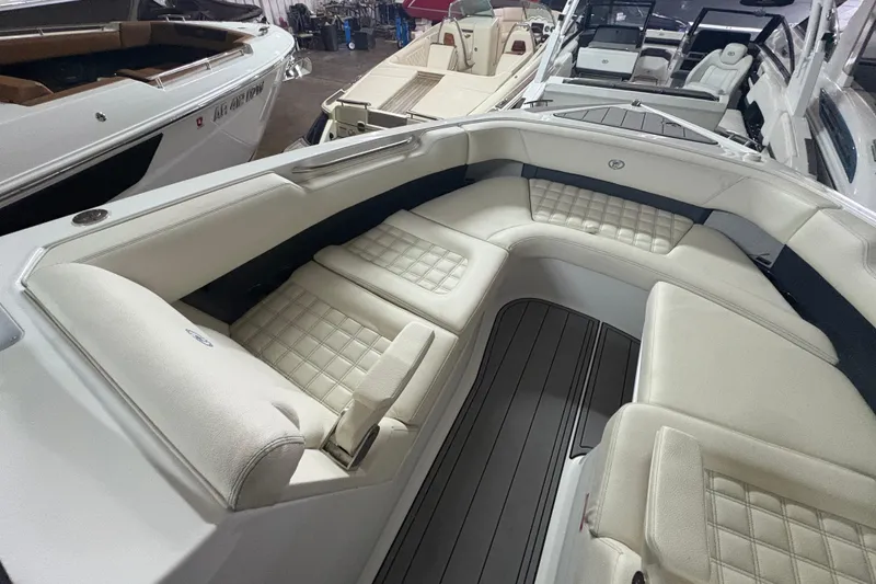 Slide: The Image of 2021 Cobalt R30 boat interior with luxurious white seating and sleek design. - 8