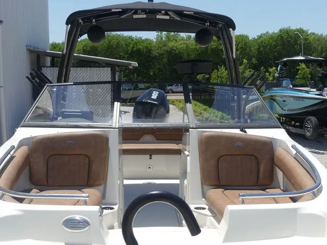 Slide: The Image of 2020 Stingray 201 DS boat with brown seats and black canopy. - 15