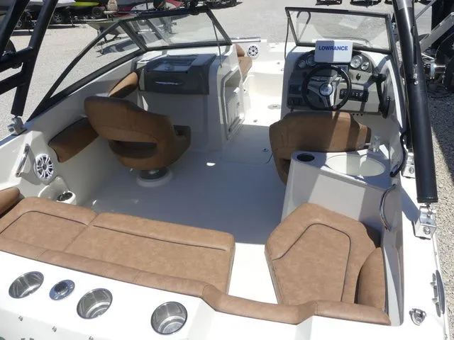 Slide: The Image of Interior of a 2020 Stingray 201 DS boat with brown seating. - 21