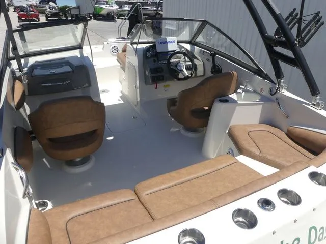 Slide: The Image of Interior of a 2020 Stingray 201 DS boat with brown seating. - 22