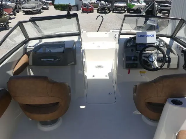 Slide: The Image of Interior view of a 2020 Stingray 201 DS boat with brown seats. - 23