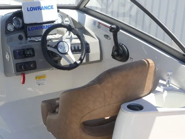 Slide: The Image of Interior of 2020 Stingray 201 DS boat with steering console. - 24