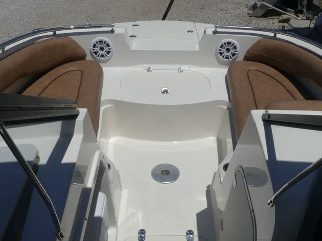 Slide: The Image of Interior of a 2020 Stingray 201 DS boat with brown seating. - 26