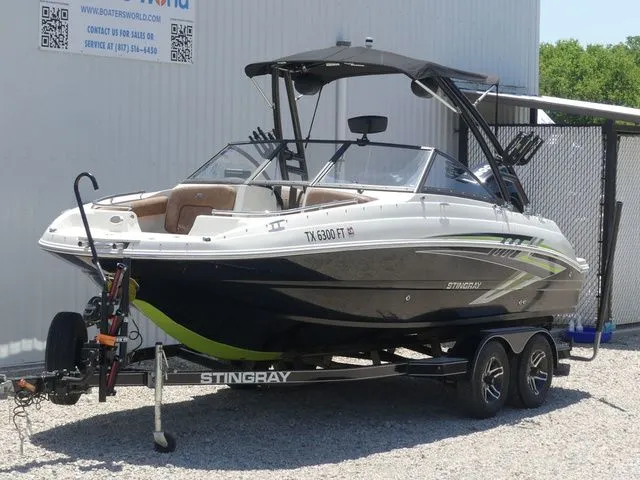 Slide: The Image of 2020 Stingray 201 DS boat on trailer in front of building. - 3
