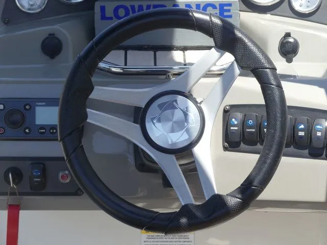 Slide: The Image of Steering wheel of a 2020 Stingray 201 DS boat with Lowrance controls. - 37