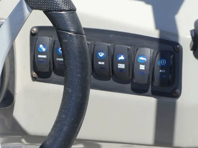 Slide: The Image of Control panel of a 2020 Stingray 201 DS boat with steering wheel. - 39