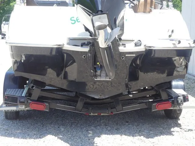 Slide: The Image of Rear view of damaged 2020 Stingray 201 DS boat on trailer. - 9