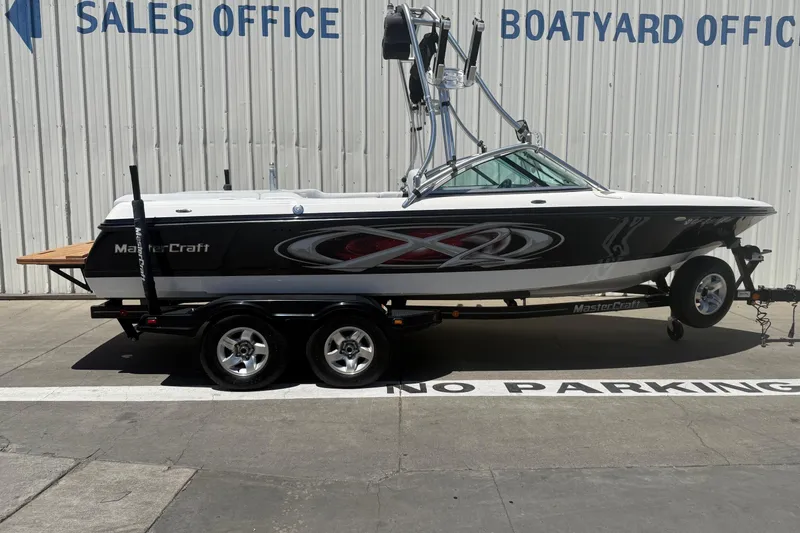 The Image of 2003 MasterCraft X2 boat on trailer outside sales and boatyard office. - 0