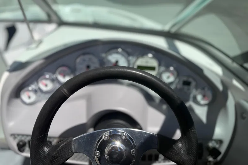 Slide: The Image of Steering wheel and dashboard of a 2003 MasterCraft X2 boat. - 15