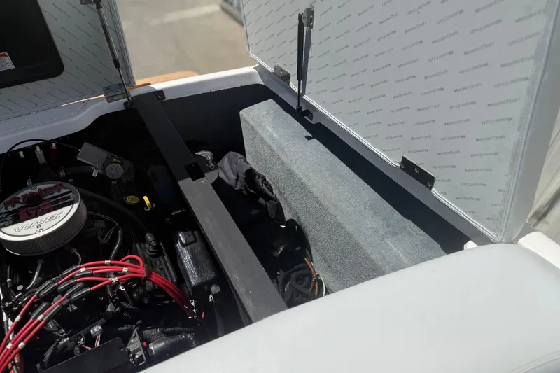 Slide: The Image of Engine compartment of a 2003 MasterCraft X2 boat with visible components and wiring. - 18