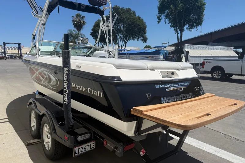 Slide: The Image of 2003 MasterCraft X2 wakeboard boat on trailer at marina, rear view. - 4