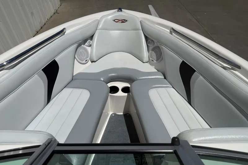 Slide: The Image of 2003 MasterCraft X2 boat interior with white and gray seating, cup holders, and speakers. - 8