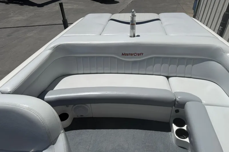 Slide: The Image of 2003 MasterCraft X2 boat interior with white seating and cup holders. - 9