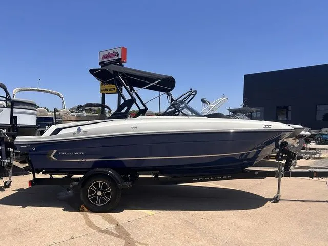 Slide: The Image of 2022 Bayliner VR4 Bowrider boat on trailer outdoors. - 2