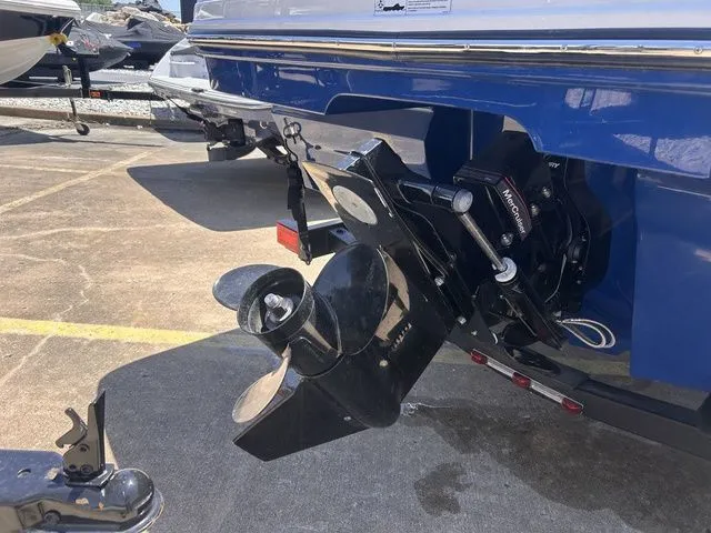 Slide: The Image of Bayliner VR4 Bowrider 2022 with outboard motor on a parking lot. - 4