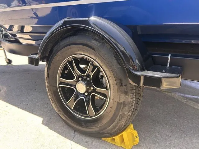Slide: The Image of 2022 Bayliner VR4 BOWRIDER trailer tire on yellow chock. - 6