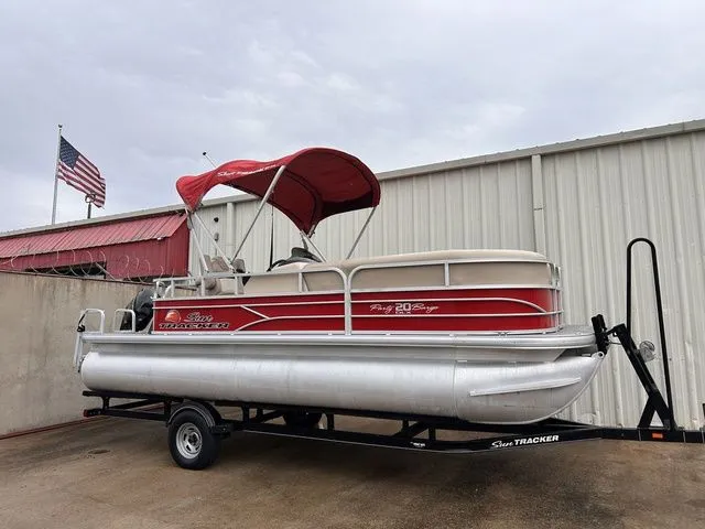 The Image of 2016 Sun Tracker Party Barge 20 DLX on trailer outside warehouse. - 1