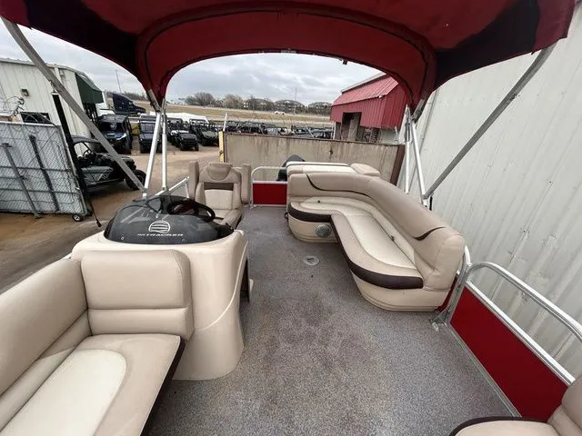 Slide: The Image of 2016 Sun Tracker Party Barge 20 DLX with red canopy and beige seating. - 10