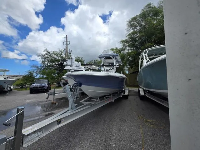 The Image of 2025 Caymas 26 HB boat parked on trailer outdoors. - 1