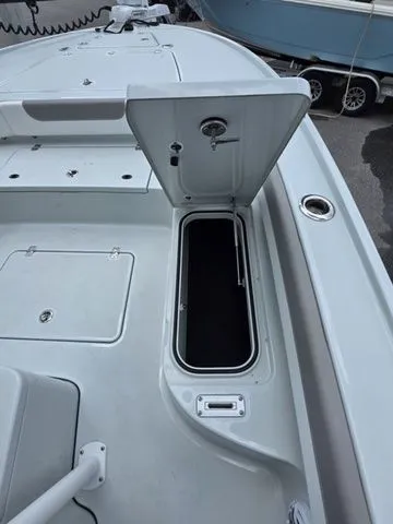Slide: The Image of Caymas 26 HB 2025 boat with open storage compartment. - 13