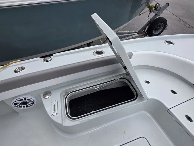 Slide: The Image of 2025 Caymas 26 HB boat with open storage compartment. - 14