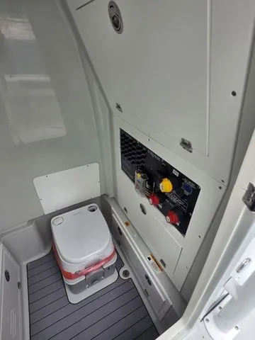 Slide: The Image of Interior of 2025 Caymas 26 HB with controls and portable toilet. - 19