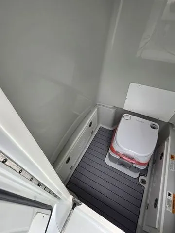 Slide: The Image of Interior of 2025 Caymas 26 HB featuring portable toilet. - 20
