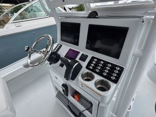 Slide: The Image of Interior view of 2025 Caymas 26 HB boat cockpit with modern controls. - 23