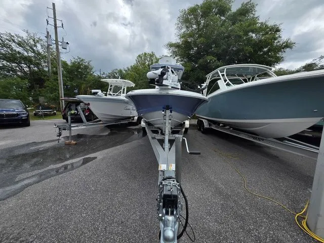 Slide: The Image of Caymas 26 HB 2025 on a trailer between two boats. - 3