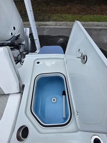 Slide: The Image of Caymas 26 HB 2025 boat with open storage compartment and blue interior. - 30