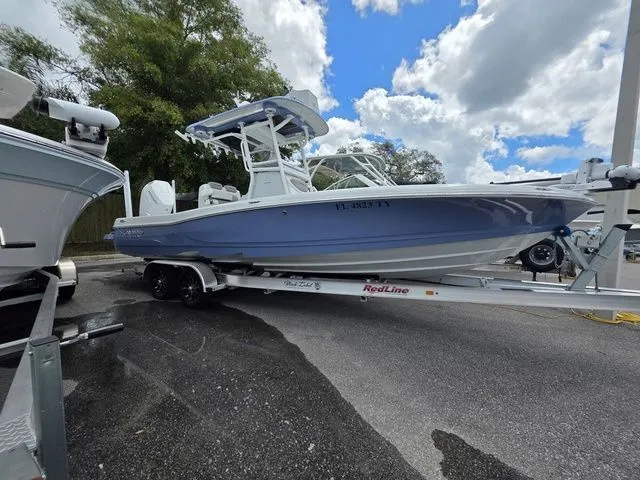 Slide: The Image of 2025 Caymas 26 HB boat on trailer under cloudy sky. - 4