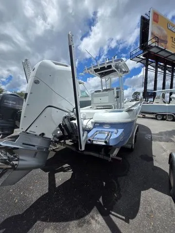 Slide: The Image of 2025 Caymas 26 HB boat on a trailer under cloudy sky. - 42