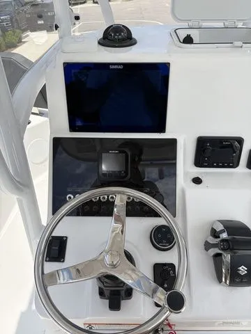 Slide: The Image of 2026 Sea Pro 250 Bay Boat dashboard with steering wheel and controls. - 11