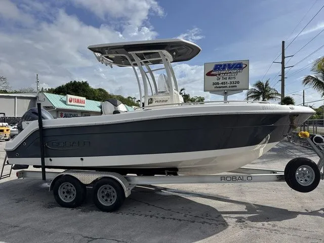 The Image of 2022 Robalo R222 Explorer boat on trailer outdoors. - 1