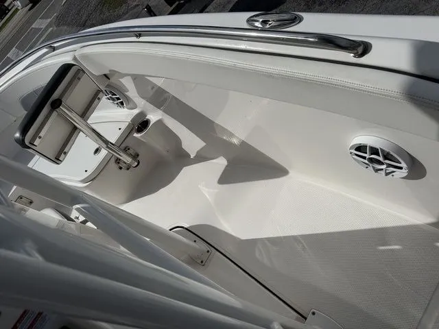 Slide: The Image of Interior of 2022 Robalo R222 Explorer boat, white seating and speakers. - 16